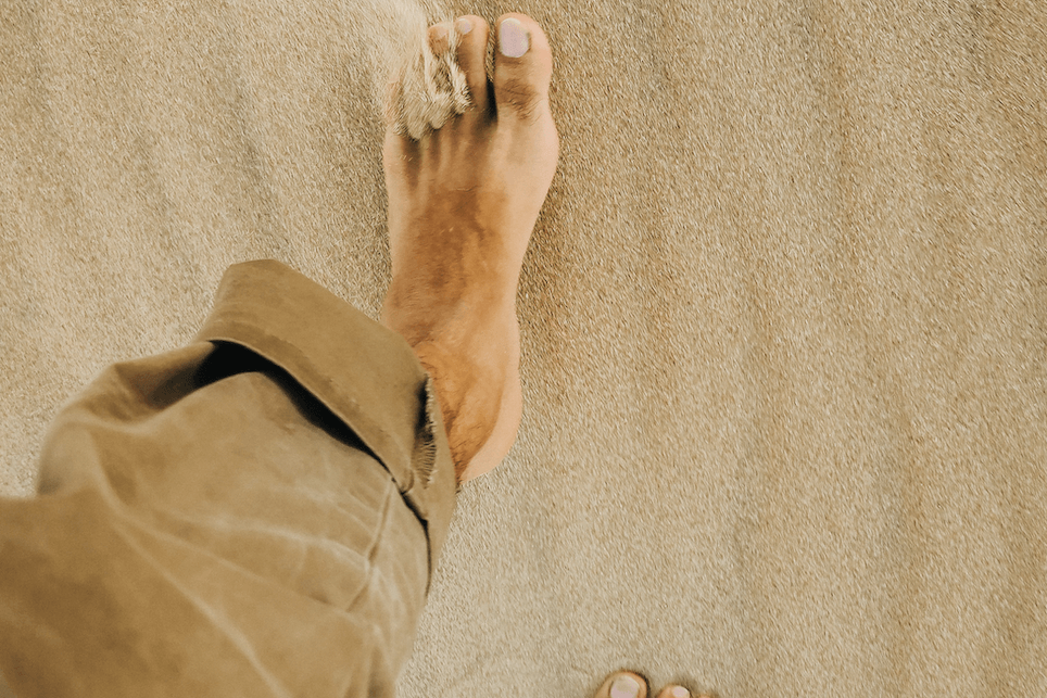 Feet walking on hot desert floor