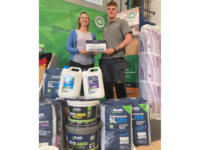 Louise Vanham, Bostik’s Category Manager – Wall & Floor, presenting George Carter with a selection of Bostik products as well as a £250 Love2Shop voucher